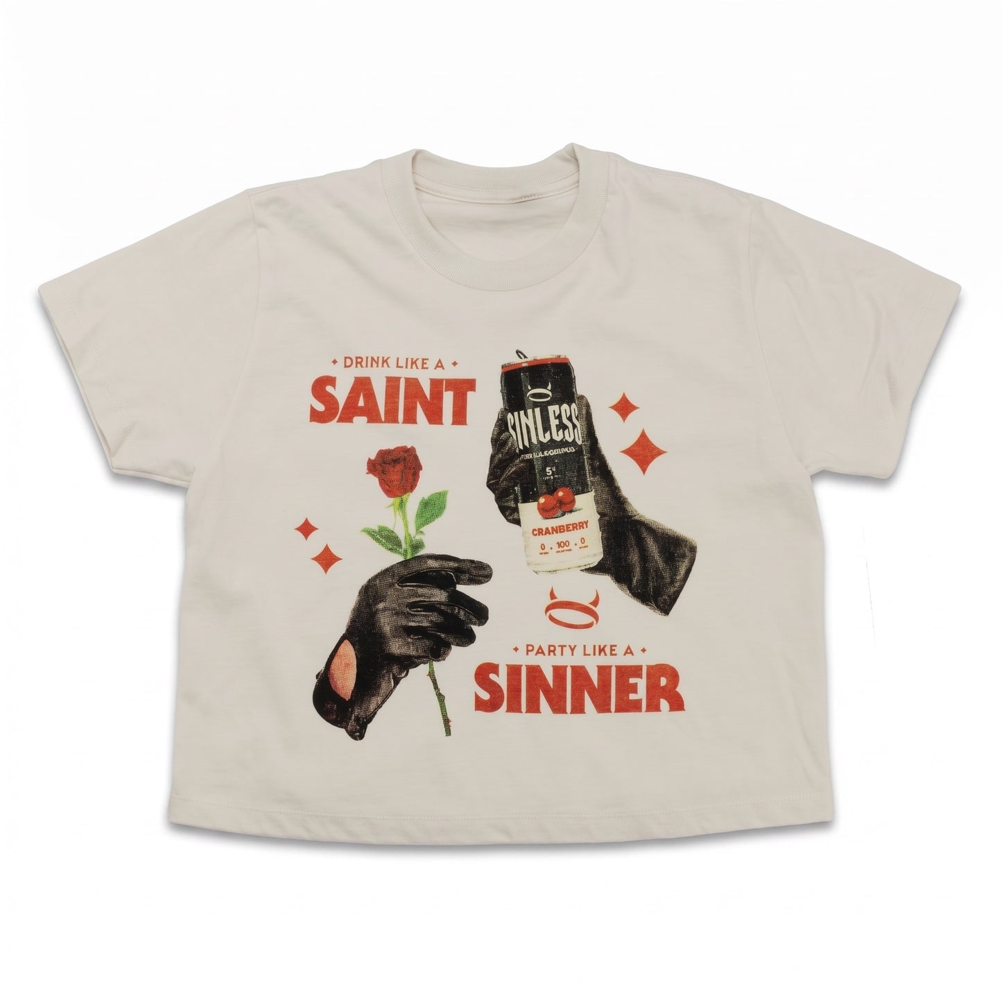 A light beige graphic t-shirt featuring a vintage-style print with a red rose, black-gloved hands, and beer cans, with text reading 'SAINT' and 'SINNER'.