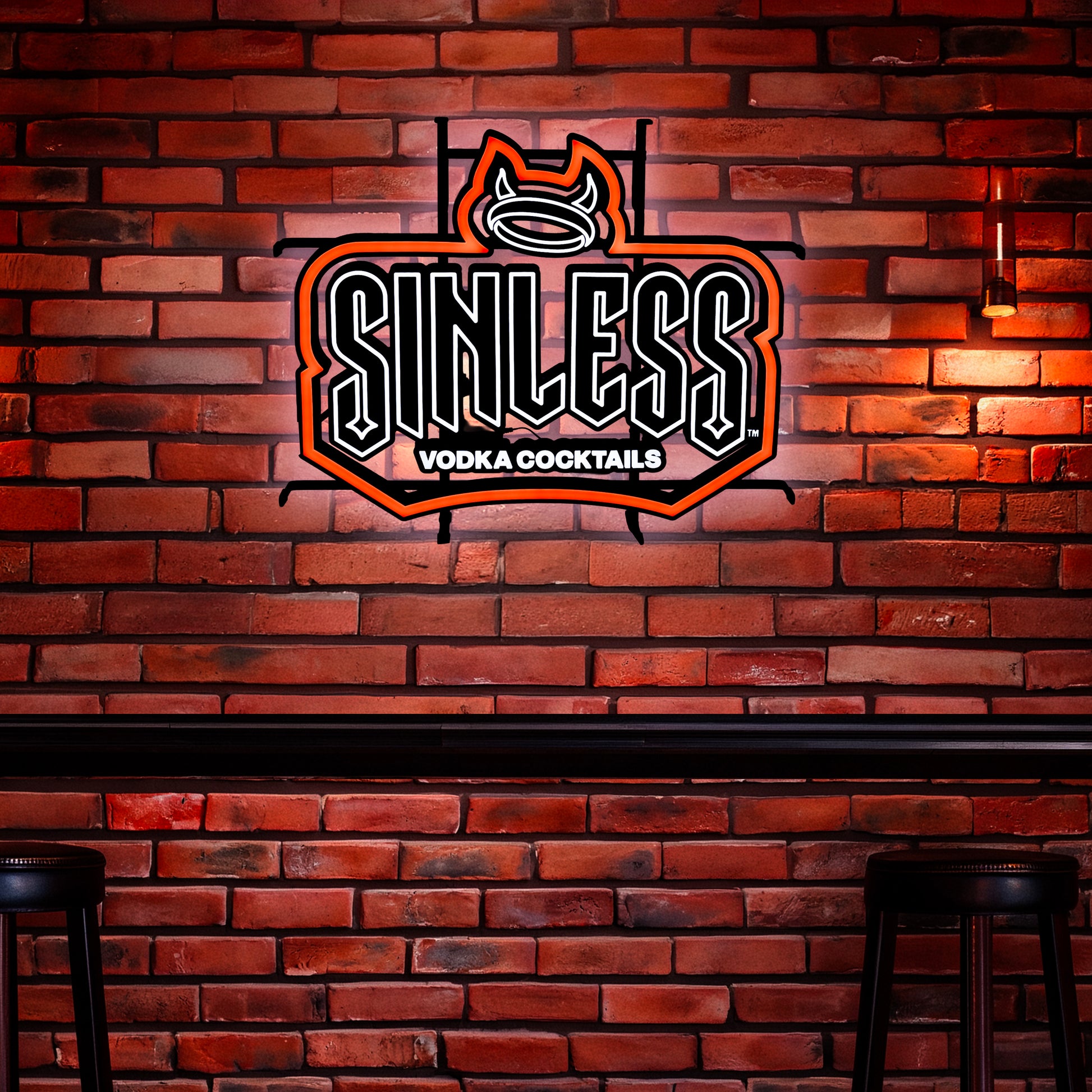 Sinless Vodka Cocktails LED neon sign mounted on brick wall with glowing red outline and devil horn halo logo bar decor lighting